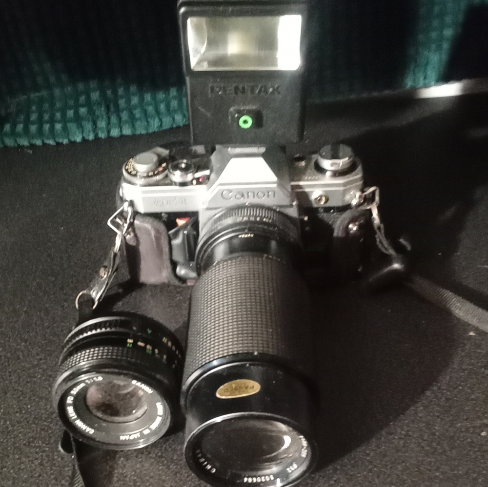Canon AE1 Black and Silver SLR Camera with Pentax Flash and zoom lens
